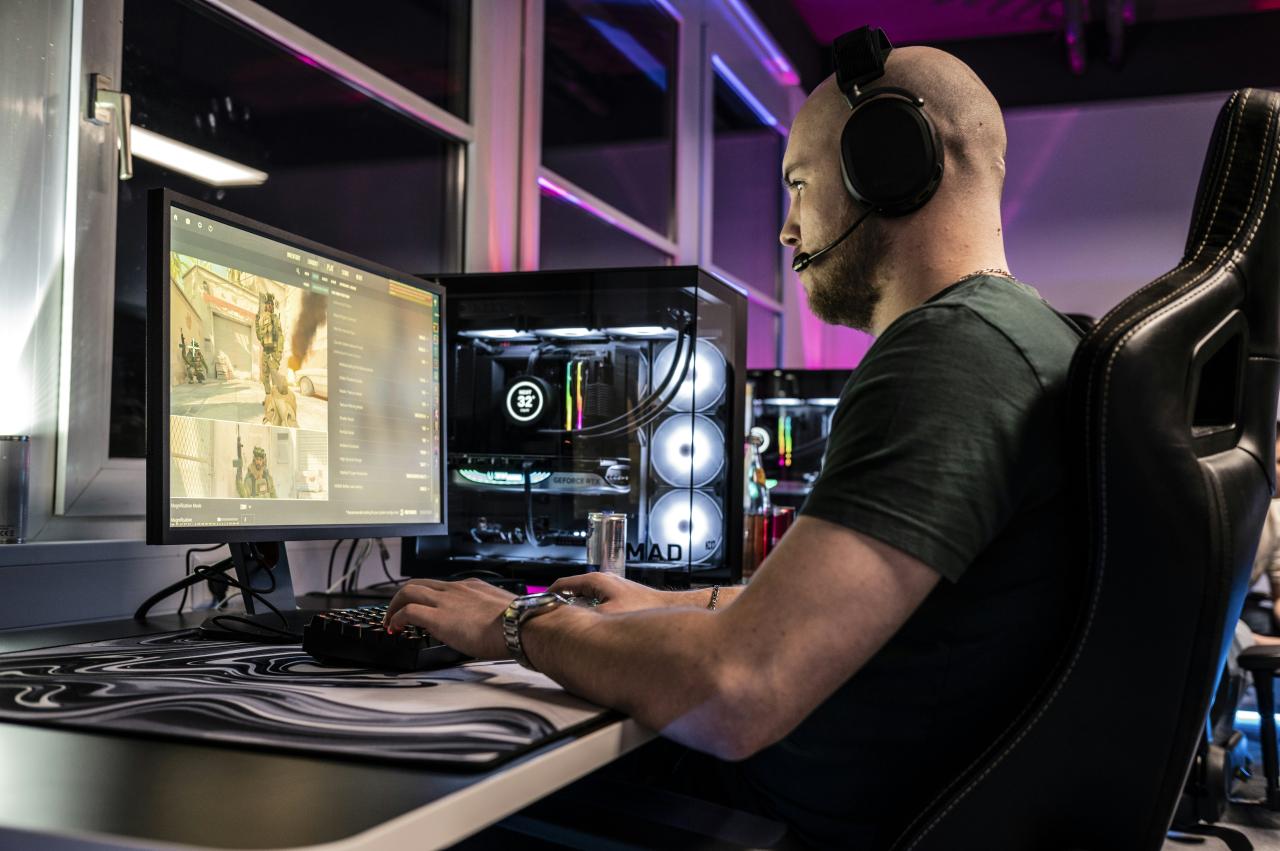 A man sitting in front of a computer monitor