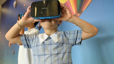 boys using blue and black virtual reality headset