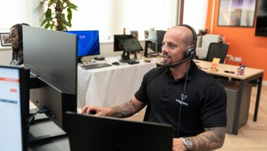 a man wearing a headset sitting in front of a computer