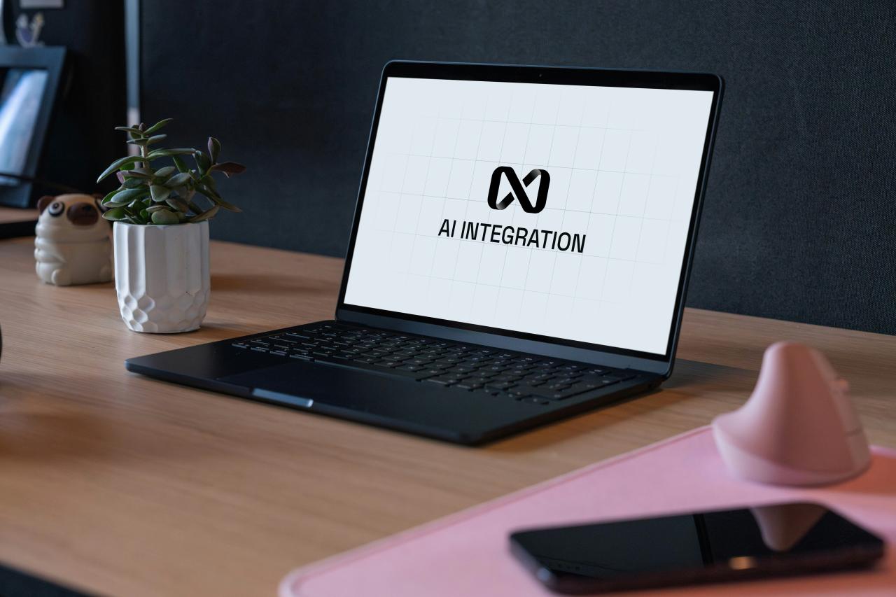 Laptop displaying ai integration logo on desk